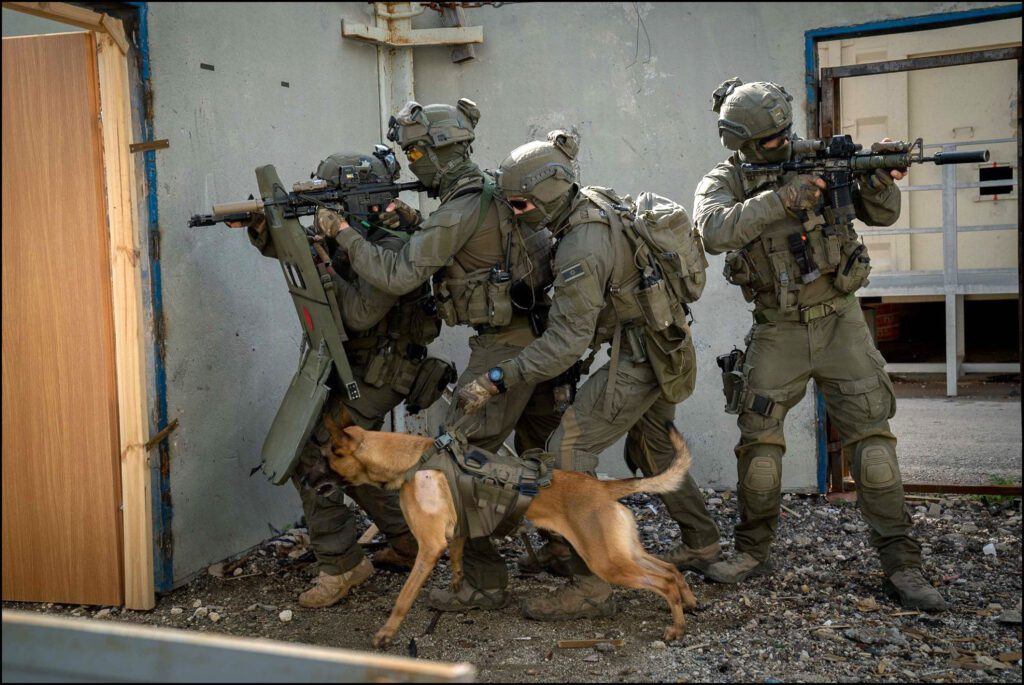 Armed soldiers with a trained dog