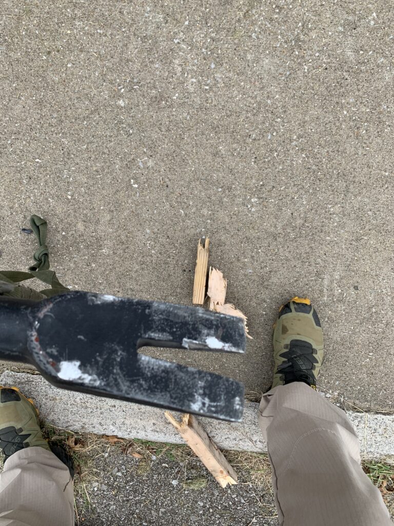 Close-up of the marred, overly thick fork end of a Blackhawk Dynamic Entry DE-HT Hallagan Tool after contact with a steel door during mechanical breaching.