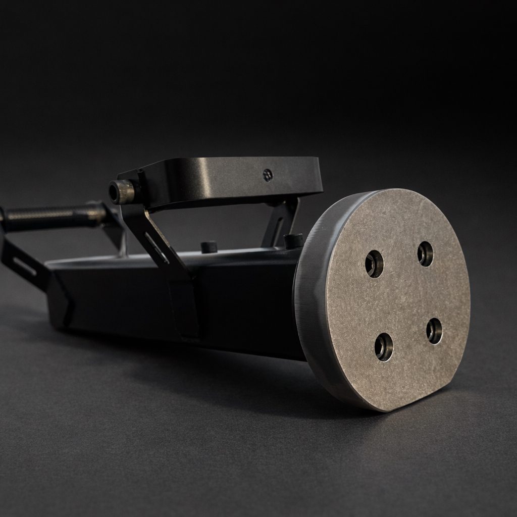 Front three-quarter view of the Breach Pro BR1 battering ram showing the circular AR400 steel strike face, suspension grips, and compact steel body designed for controlled, kinetic door breaching.